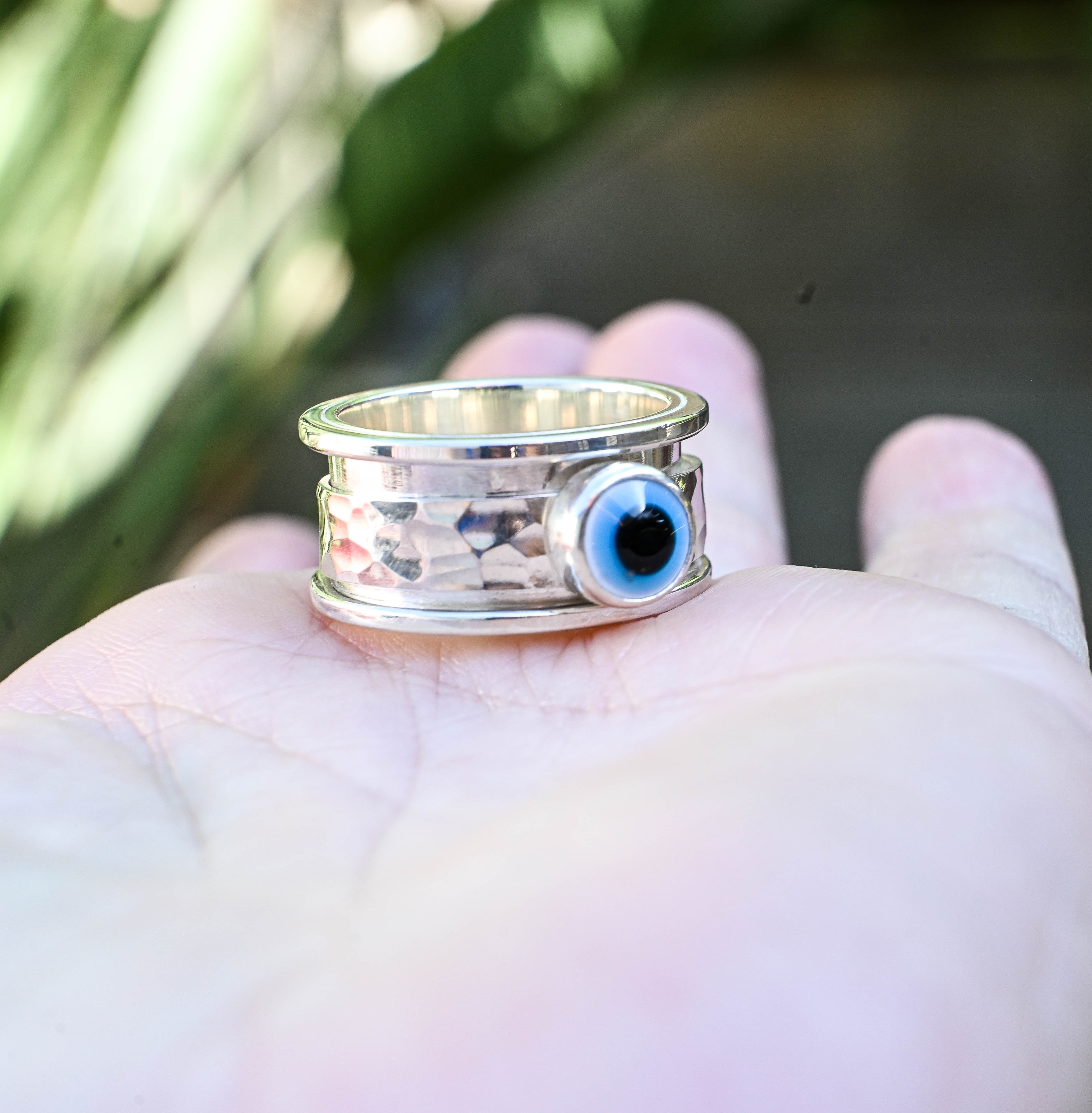 Spinner δαχτυλίδι ασήμι με evil eye στο χέρι παλάμη ανοιχτή εξωτερικός χώρος