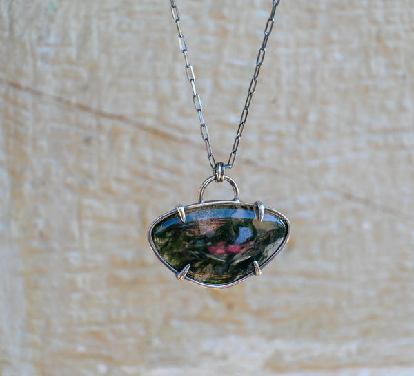 Χειροποίητο μενταγιόν με πράσινο αχάτη moss agate και αλυσίδα, σε πετρινο φόντο.