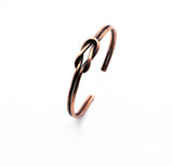 Handmade copper bracelet with the knot of love