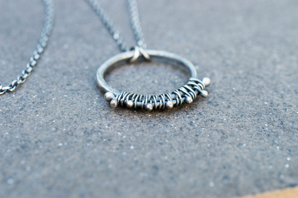 Silver circle necklace with oxidation